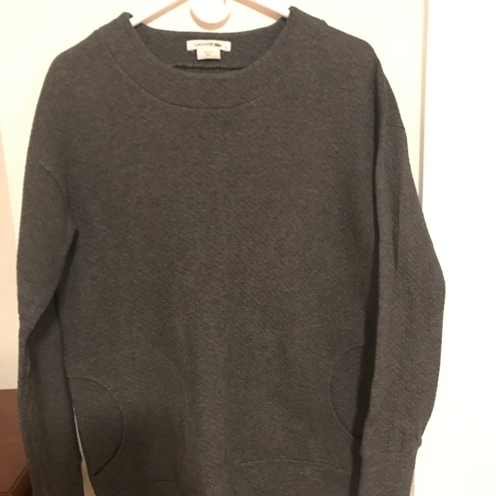 A gray Lacoste sweater